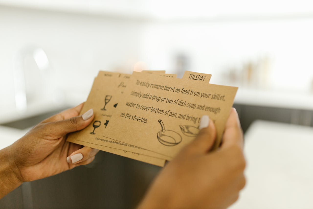 Woman holding instructional cards with text and illustrations.